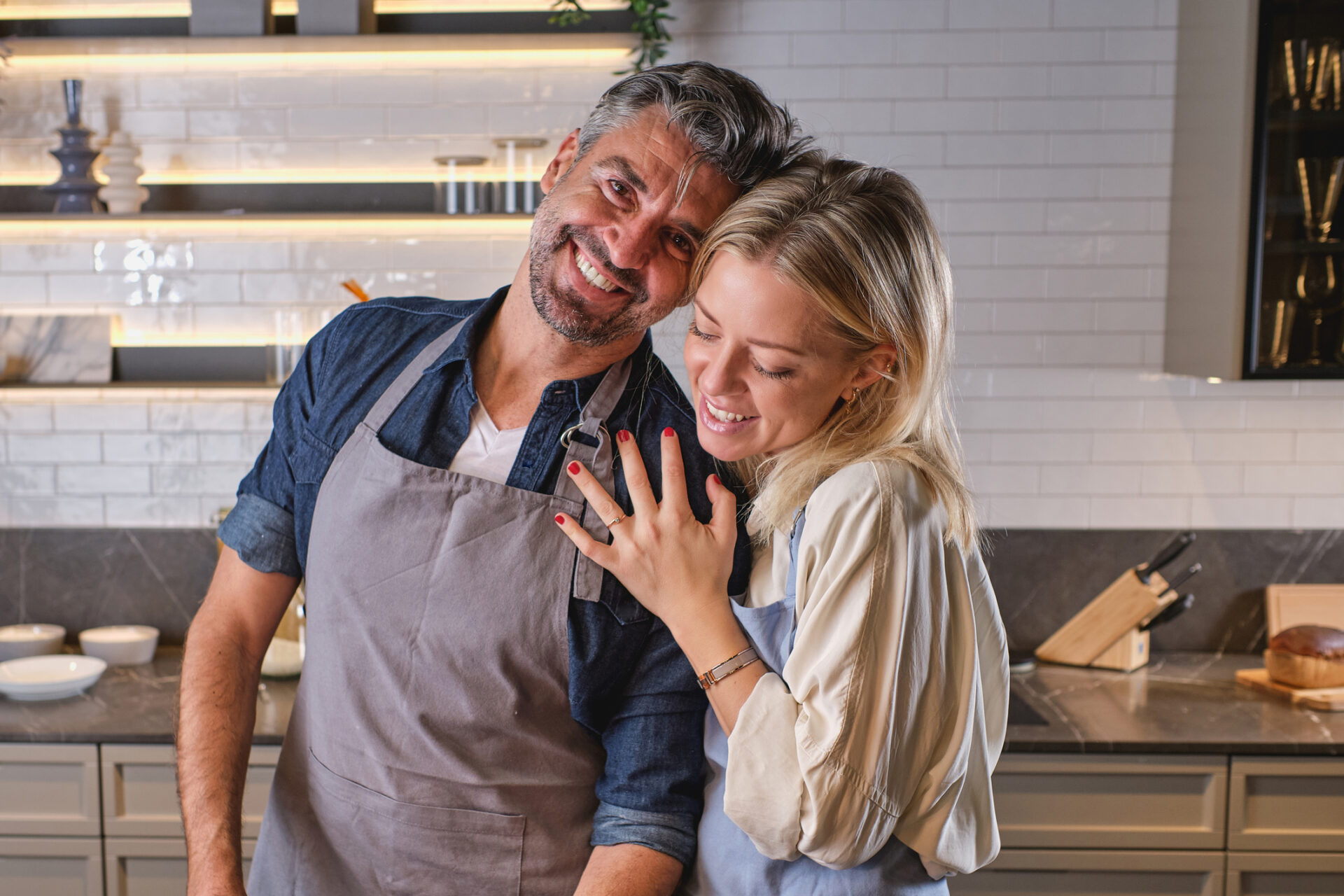 Happy couple hugging in kitchen