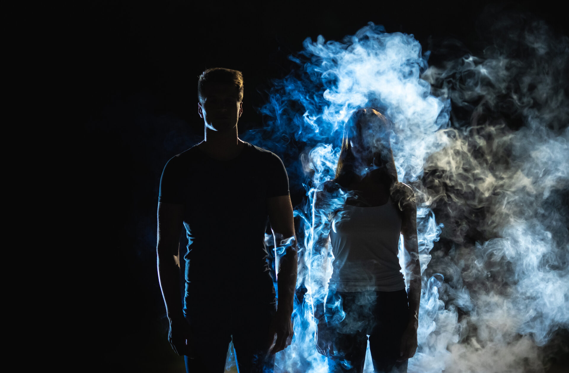 The man and woman standing in the smoke